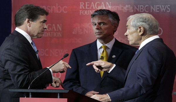Texas Gov. Rick Perry, left, and Rep. Ron Paul (R-Texas), right, speak during a break, as Jon Huntsman looks on during the Republican presidential debate at the Reagan Presidential Library in Simi Valley, California, Wednesday, September 7, 2011. (Lawrence K. Ho/Los Angeles Times/MCT)
