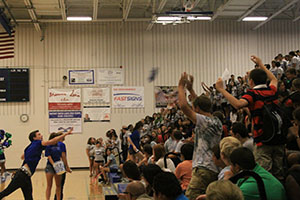 Senior Eric OBrian throws shirts to new students during the welcoming assembly on Aug 30.