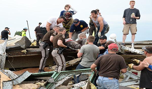 An injured person is removed from the rubble in the aftermath of a huge tornado that struck Moore, Oklahoma, Monday, May 20, 2013. At least 51 people were killed, including at least 20 children, and those numbers were expected to climb, officials said Tuesday. (Gene Blevins/Zuma Press/MCT)