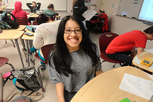 Freshman Paloma De La Lama getting her homework checked in math class.