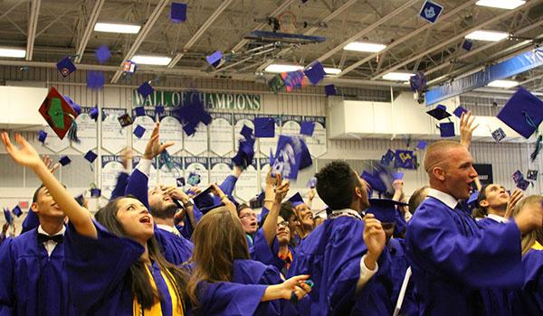 Class of 2013 toss their caps as tradition celebrating their conclusion of high school.