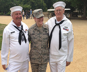 Junior Kayla Viaus mother Nicole Lucas poses with retired sailors at the Memorial Day Parade.