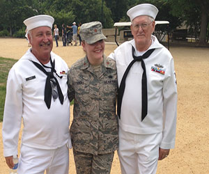 Junior Kayla Viau's mother Nicole Lucas poses with retired sailors at the Memorial Day Parade.