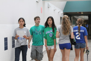 Senior mentor Nina Shazad (far left) walks the halls with juniors Daniel Gurley and Michelle Ma during freshmen orientation day. Mentors provide guidance for new students throughout the school year. 