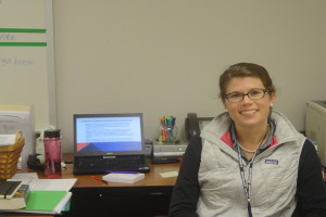 English teacher Emily Brown poses at her desk. Brown joined the faculty this year after working as an admissions counselor. 
