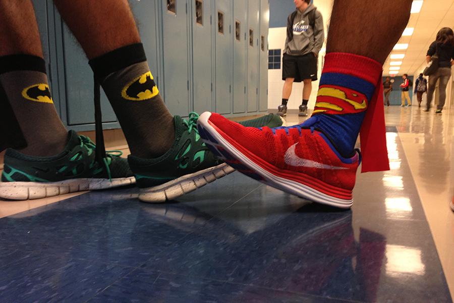 Seniors+Jojo+Kidane+and+Tyler+Liboro+show+off+their+Batman+and+Superman+socks+respectively.+