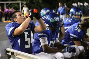 Senior football captain Alex Woodward takes a water break during the Sept. 6 Westfield game.