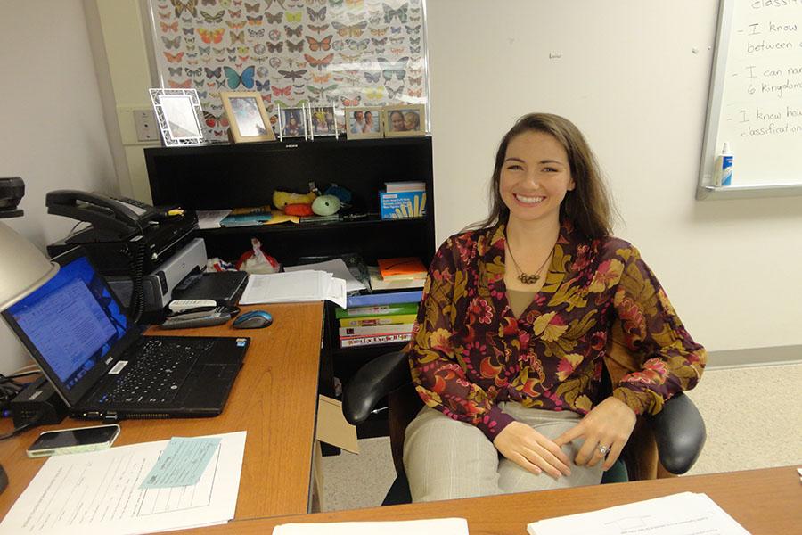 Biology teacher Alyssa Waters sits behind her new desk in room 205.