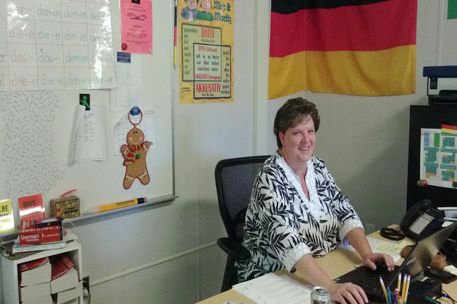 German+teacher+Cheryl+Finley+sits+at+her+desk+during+her+8th+period+class.