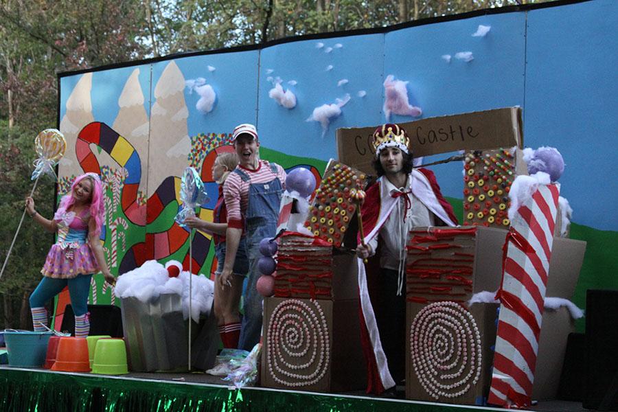 Seniors Allison Scheler, Josh Brust, and Sammy Nazam ride in the homecoming parade on Class of 2014's Candyland themed float. 