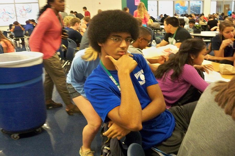 Boys volleyball player senior Jojo Kidane shows off his team spirit by wearing his jersey to school before the teams home game against Oakton Oct. 3. Boys volleyball has a winning record this season. 