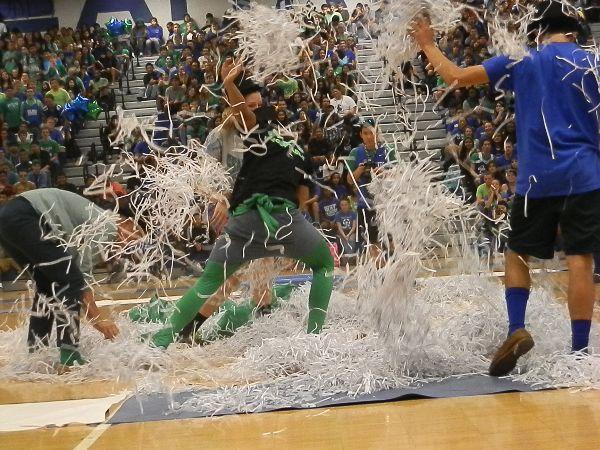 Representatives from each class compete to find a board game piece during a school pep rally. 