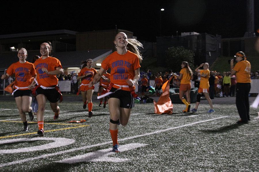 Class of 2014 powderpuff players take the field with senior Lindsey Gibson leading the charge. Seniors were ultimately victorious over their junior opponents. 
