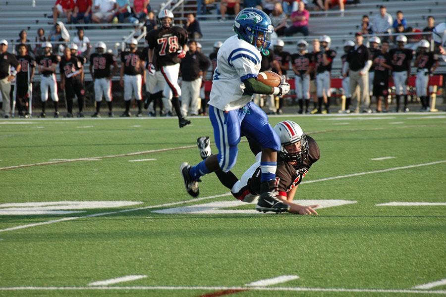 A freshman runningback avoids a tackle as he drives the ball toward the end zone during the game against Herndon Sept. 19.  