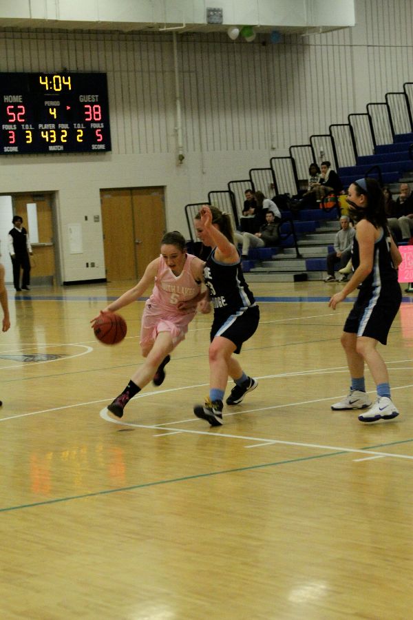 Senior Caitlin Jensen drives to the net during a game against Stone Bridge last year. 