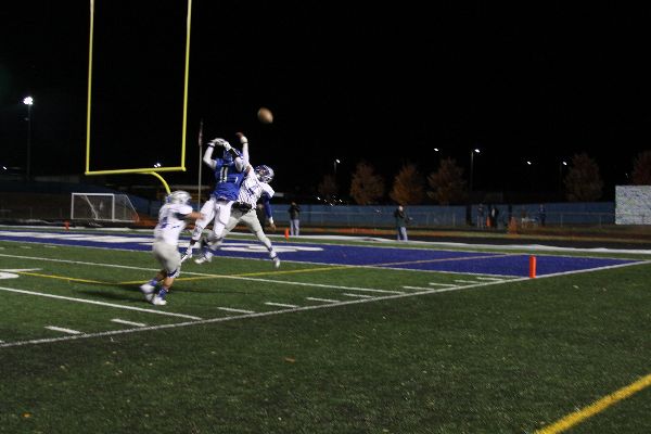 Senior wide receiver Akram Gibreel attempts to catch the ball near the end-zone amidst interference from Fairfax defense. 