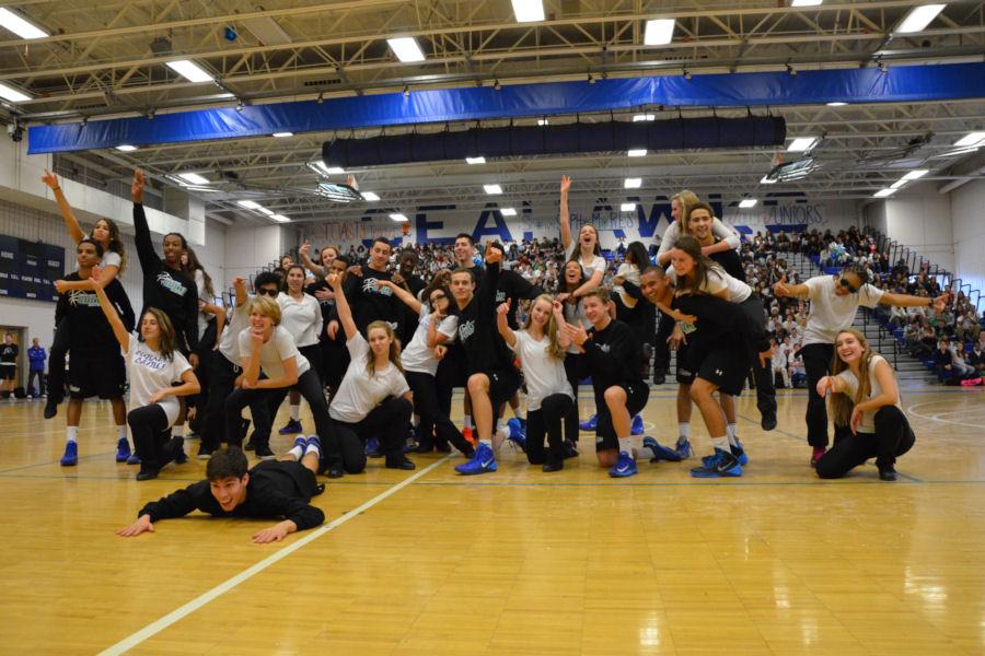 Dance team members and male basketball players strike a pose after their joint performance during the winter pep rally. 