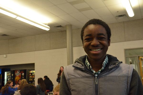 Freshman Nathan Nkomba smiles in the cafeteria during lunch. 