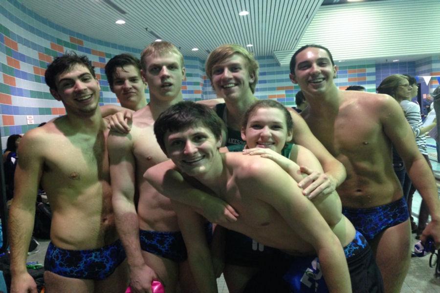 Senior swimmers (from left to right: Matt Hutchins, Greg Blanpied, Tyler Hutson, Ben Gallagher, Mark Lawson, Mel Anderson, and Jerrett Gulakowski) pose during their final home swim meet. 