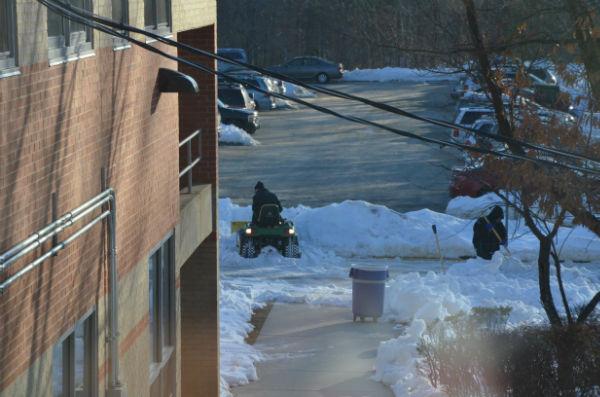 Administration works on cleaning the pathways in preparation for the first school day since the Feb. 13 snow storm.