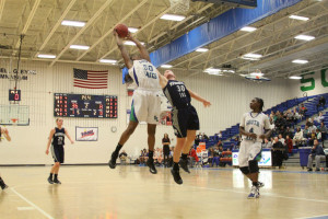 Junior forward Princess Aghayere grabs an offensive rebound in the final seconds of the second quarter during a game against Washington-Lee Jan. 24.  Aghayere posted a double double with 12 points and 12 rebounds in the team’s 58-25 win.