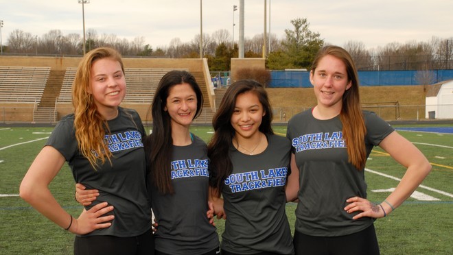 Senior+track+and+field+athletes+Abby+Reinhold%2C+Grace+Gillen%2C+Kristin+Tran%2C+and+Danielle+Hale+%28from+left+to+right%29+pose+in+front+of+the+South+Lakes+track.++
