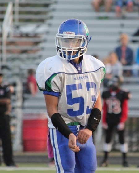 QRU? freshman football player Alex Stoffel dresses for the varsity football team