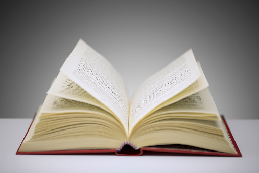 Close up of open book on counter; photo taken from http://time.com/3936846/powerful-books-list/