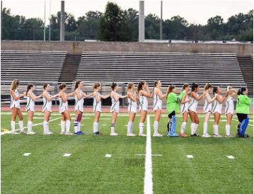 SLHS Varsity Field Hockey lining up before a home game - @mm_snips on Instagram