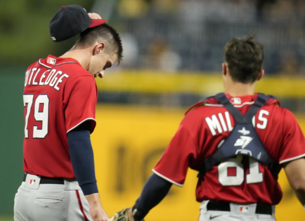 Pictured: Catcher Drew Millas checked in on Rutledge after he got hit on a throwdown to 2nd base. Via/AP News