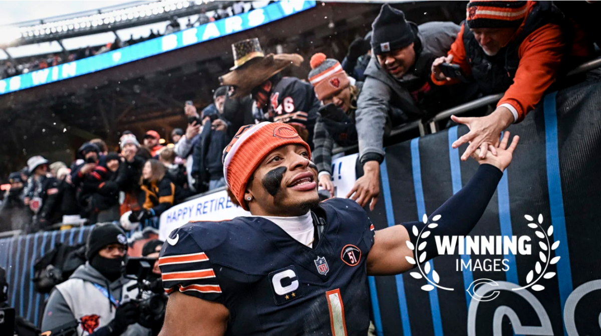 Fields high-fives fans after the Bears' blowout of the Falcons. (via/ChicagoBears.com)